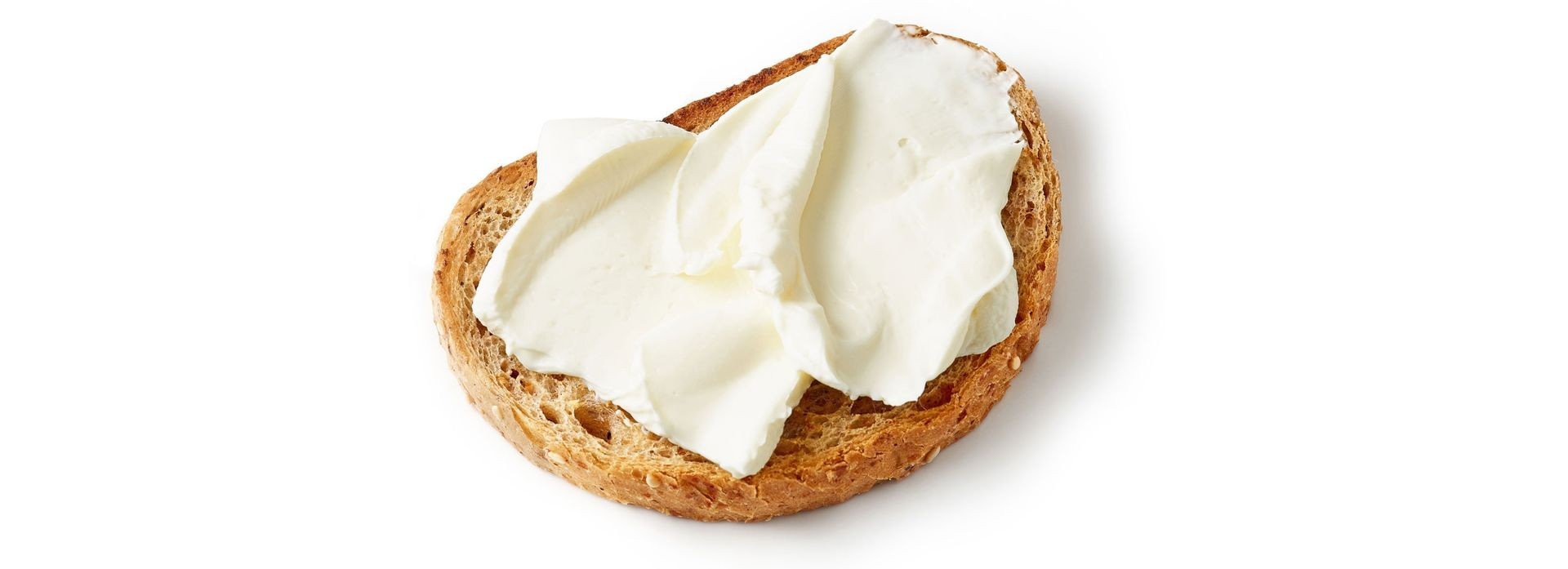 Slice of bread topped with a generous spread of cream cheese on a white background.